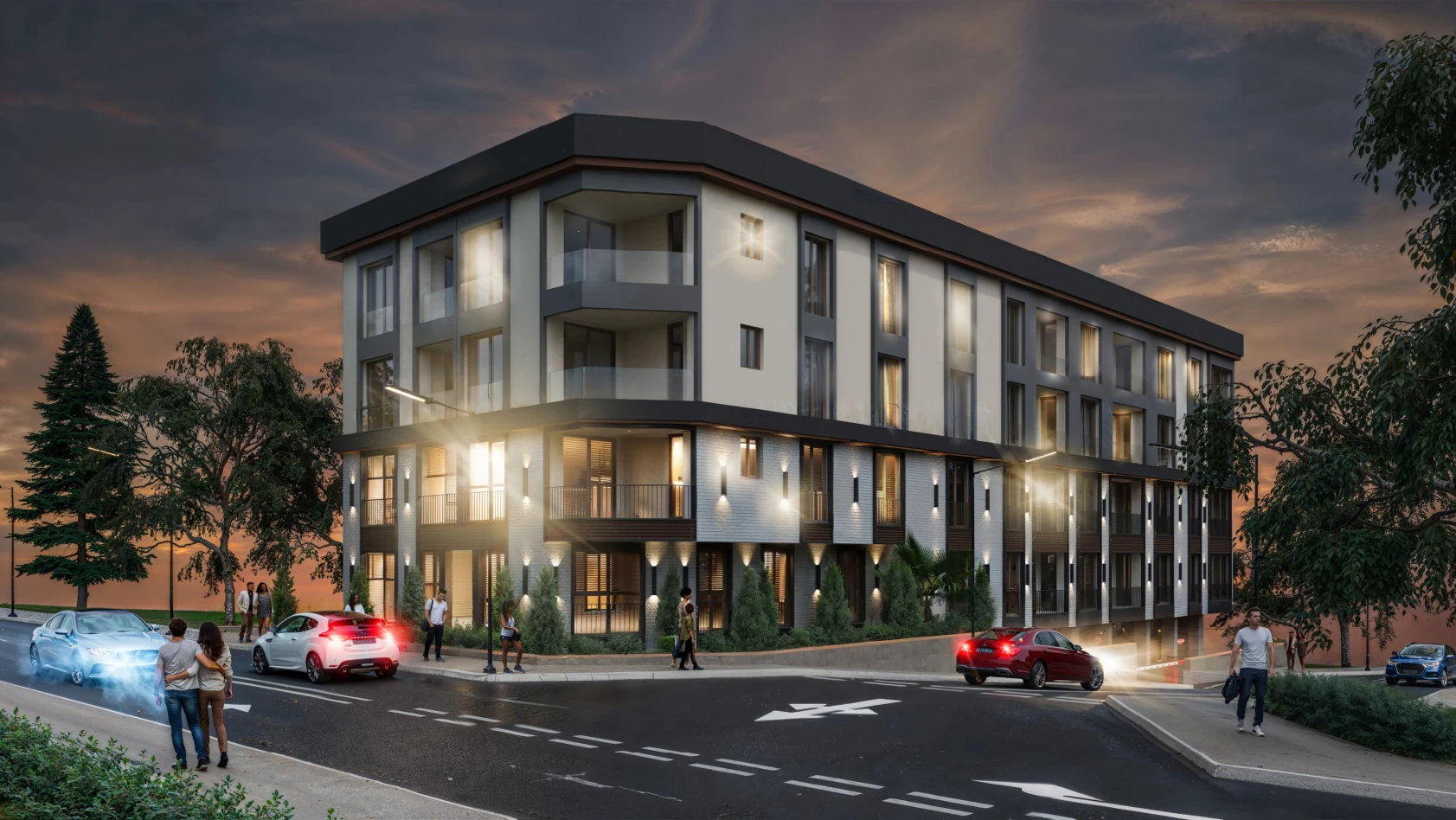 Bu görüntü, modern bir apartman binasını ve çevresini gösteriyor. Gece vakti çekilmiş olup, aydınlatılmış. Ön planda birkaç araç ve insanlar yürürken görünmekte. Arka planda ise ağaçlar ve bir manzara var. Bina, çağdaş mimarisiyle dikkat çekiyor ve sakin bir konumda yer alıyor.
