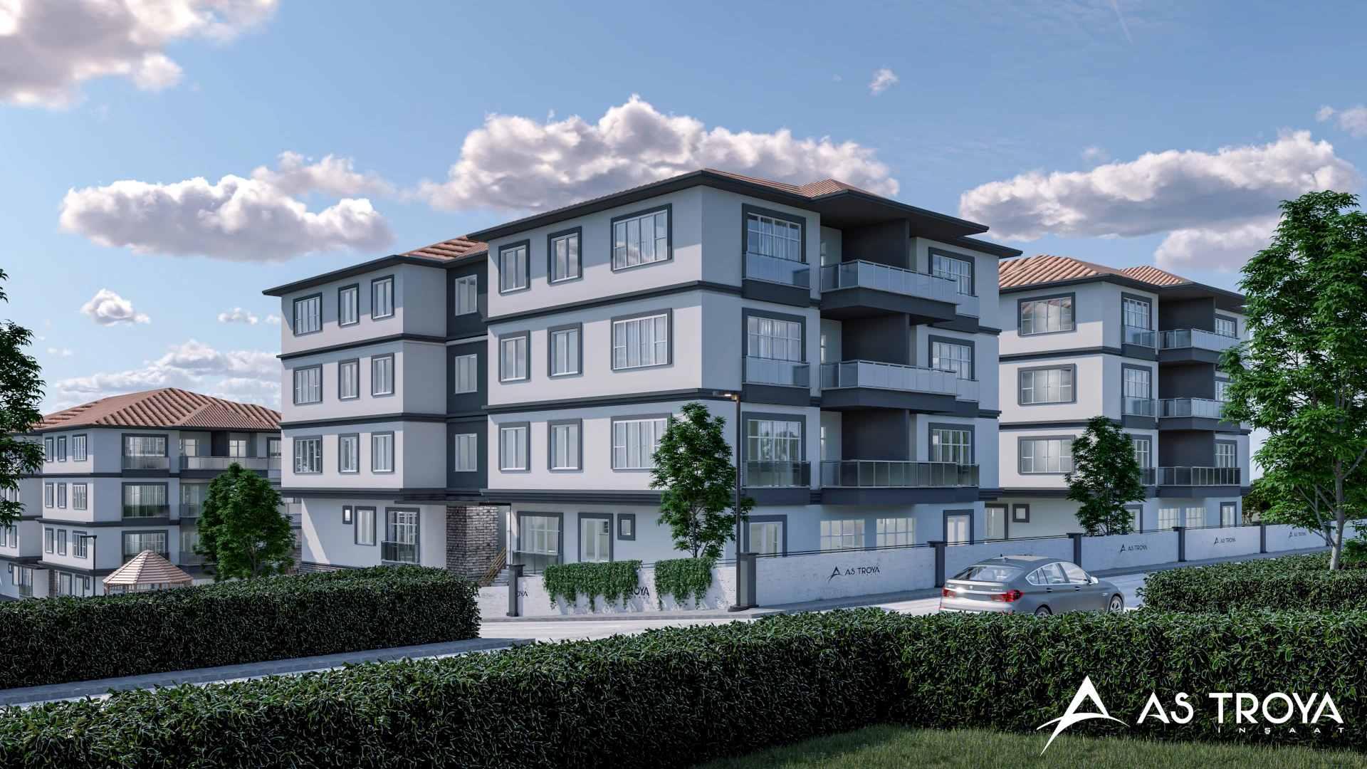 Bu görsel, modern mimari tarzda tasarlanmış bir apartman blokunu göstermektedir. Geniş pencereleri ve şık cephesiyle dikkat çeken yapı, yeşil bir peyzaj içerisinde yer almakta. Etrafta yer alan ağaçlar ve çalılar, doğal bir çevre sunarak sakin bir yaşam alanı yaratmaktadır. Apartmanın cephesinde yer alan 'AS TROVA' logosu, projeye ait kimliği vurgulamaktadır. Güneşli bir günde çekilmiş olan bu resim, sakin ve konforlu bir yaşam alanının estetiğini yansıtmaktadır.