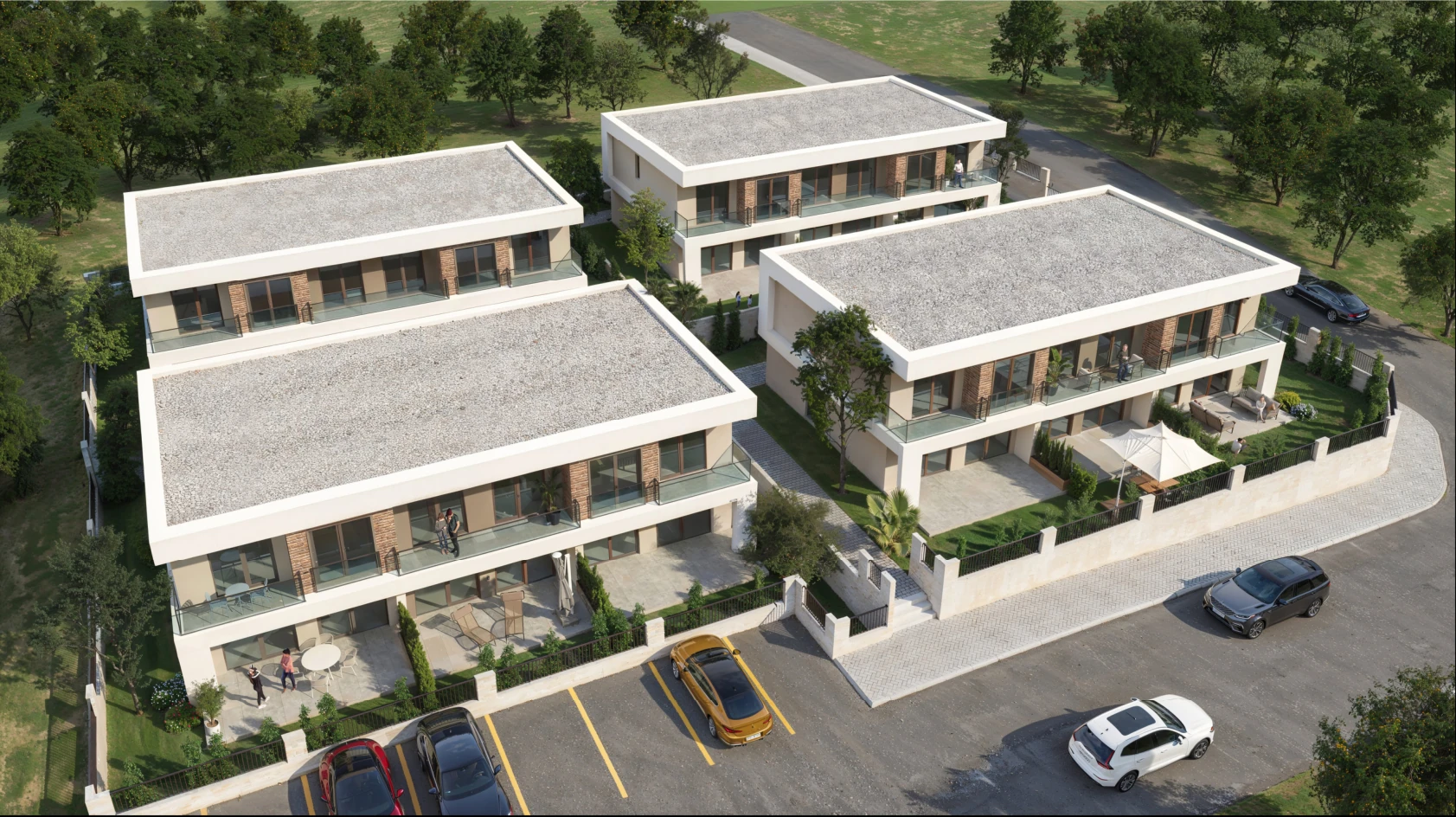 Bu görüntüde, modern mimari tarzında tasarlanmış üç adet villa yer alıyor. Villalar, geniş terasları ve yeşil alanları ile dikkat çekiyor. Çevresinde ağaçlar ve peyzaj düzenlemesi bulunan bu konutlar, sakin bir yaşam alanı sunuyor. Ayrıca, park alanı ile birlikte düzenlenmiş bir yol da görülüyor, bu da araçların rahatça park edilebileceğini gösteriyor.