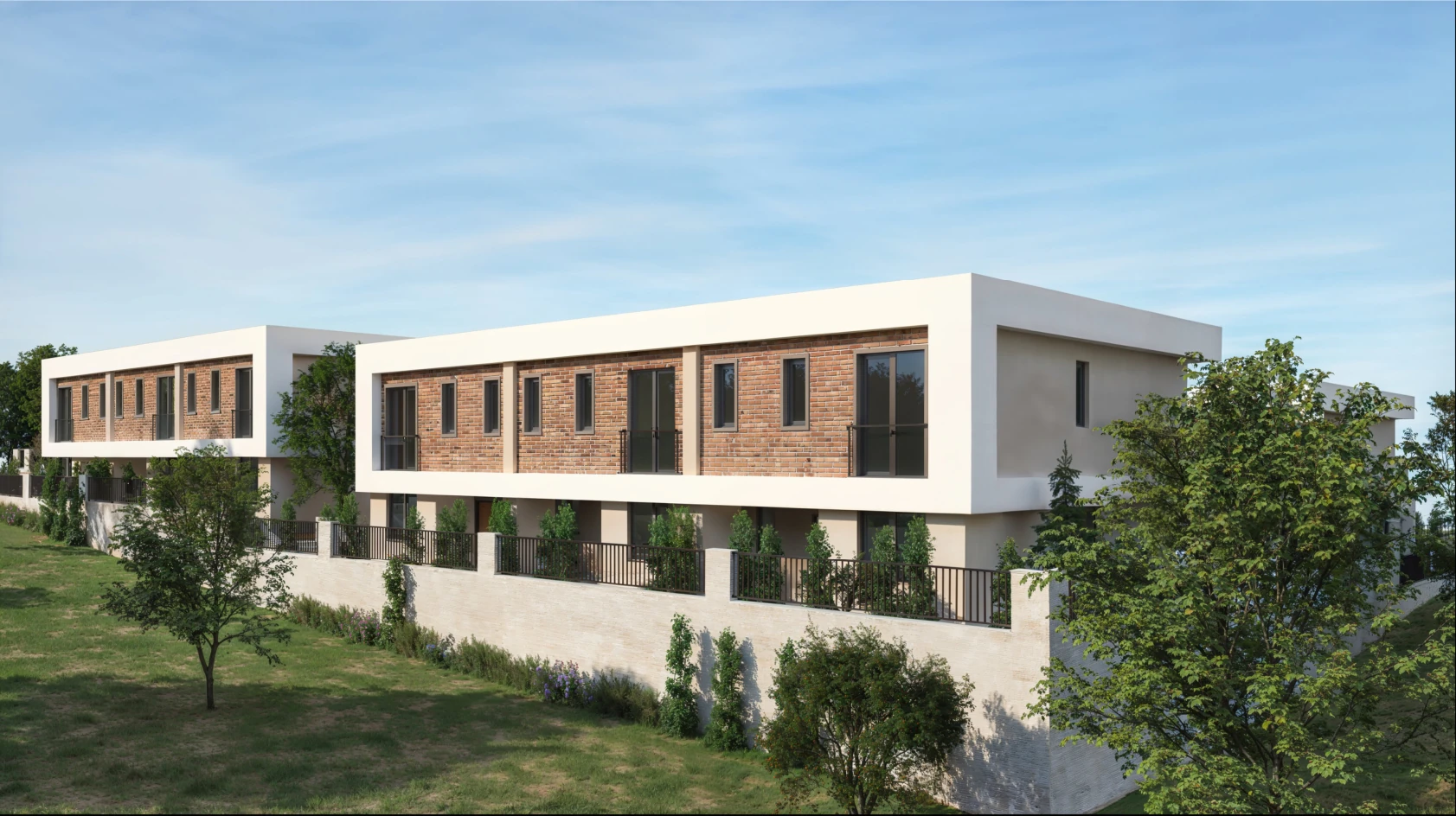 Modern bir konut projesinin dış görünümü. Görselde, yeşil bir alana yerleştirilmiş iki katlı, modern tasarımlı binalar yer alıyor. Binaların dış cephesi, doğal taş ve beyaz bir kaplama ile kombinlenmiş; pencereler geniş ve ferah bir görünüm sunuyor. Çevredeki bahçe düzenlemesi ile uyumlu bir şekilde, ağaçlar ve bitkilerle zenginleştirilmiş bir peyzaj mevcut.
